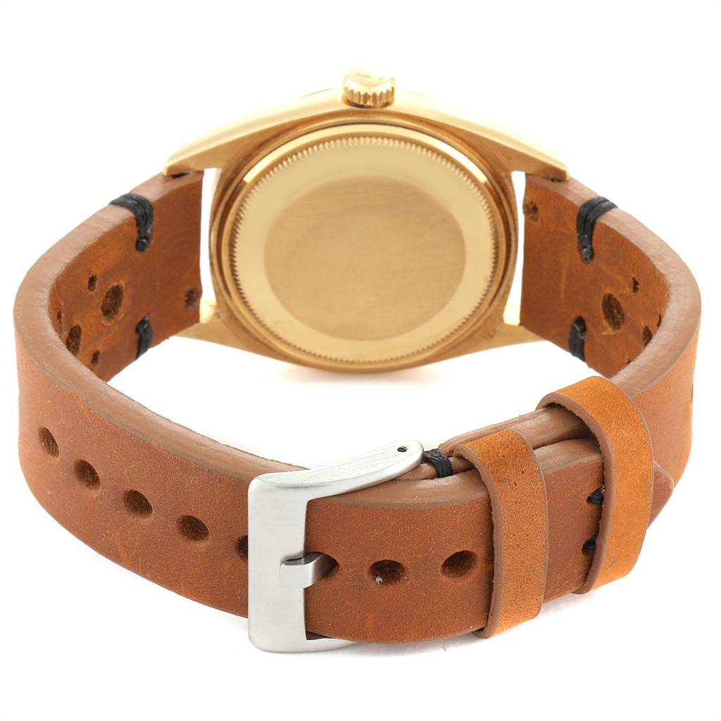 This image shows the back view of the Rolex Vintage Collection 1803 Men
s Yellow Gold Champagne Dial 1803 Men
s Yellow Gold Champagne Dial model watch, highlighting its leather strap and clasp.