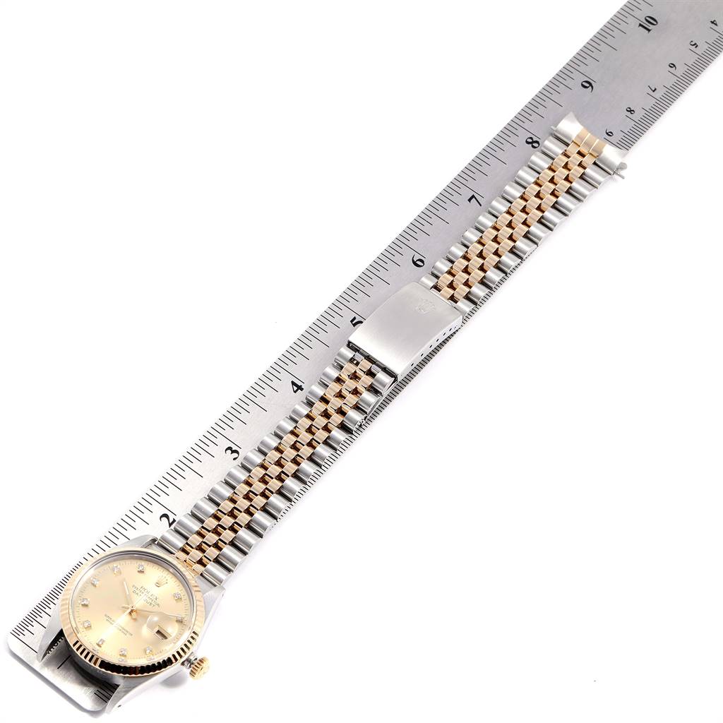 The image shows a Rolex Vintage Collection 16013 Men's Stainless Steel Champagne Dial 16013 Men's Stainless Steel Champagne Dial watch laid flat next to a ruler, displaying the watch face and bracelet.