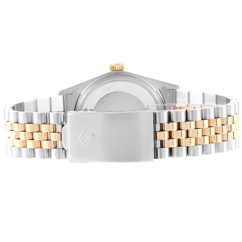 The image shows the rear view of the case and bracelet of a vintage Rolex Collection watch, featuring a clasp and the crown logo.