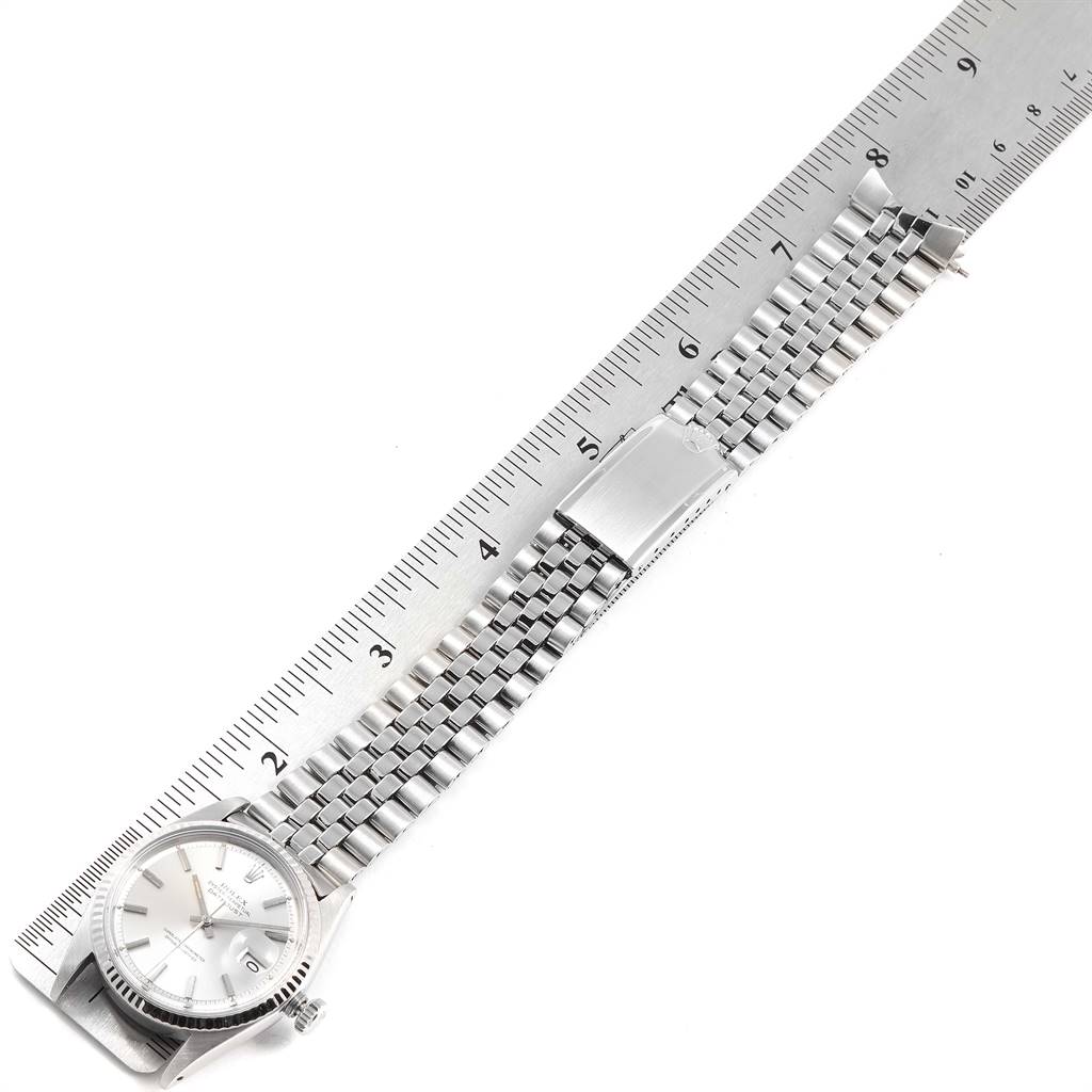 The image shows a Vintage Collection Rolex watch, featuring its face, strap, and clasp laid out flat beside a ruler.