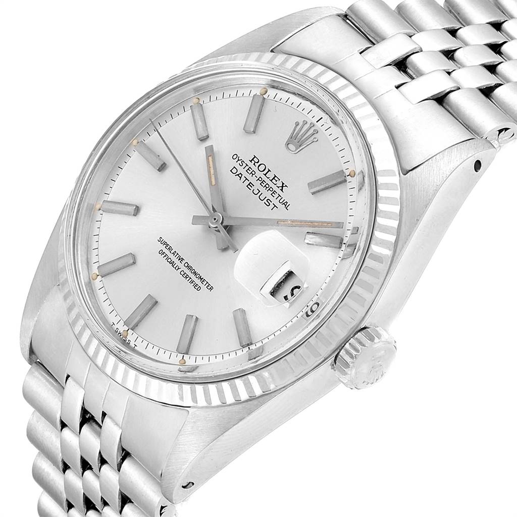The image shows a Rolex Vintage Collection 1601 Men
s Stainless Steel Silver Dial 1601 Men
s Stainless Steel Silver Dial Datejust watch at an angled close-up, highlighting its dial, hour markers, date window, bezel, and part of the bracelet.