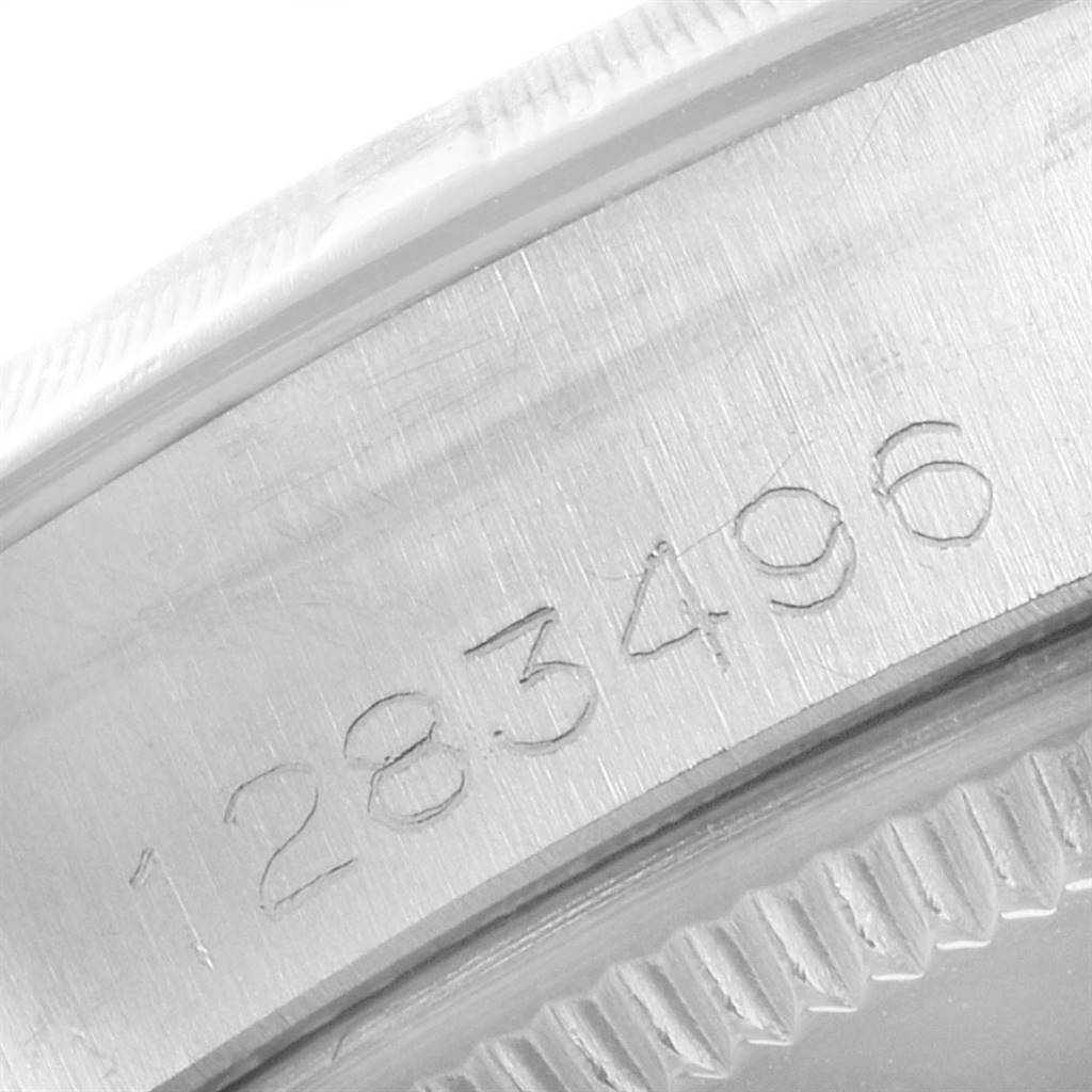 The image shows a close-up of the case side of a Rolex Vintage Collection 1003 Men
s Stainless Steel Silver Dial 1003 Men
s Stainless Steel Silver Dial watch, highlighting the serial number engraving.