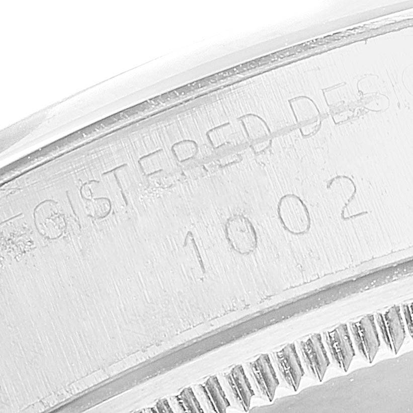 The image shows a close-up view of the case back and outer edge (fluted bezel) of a Vintage Collection model by Rolex.