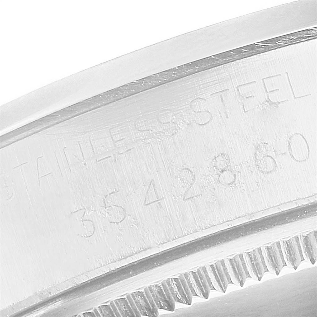 This close-up image shows the engraved serial number on the stainless steel case of a Vintage Collection Rolex watch.