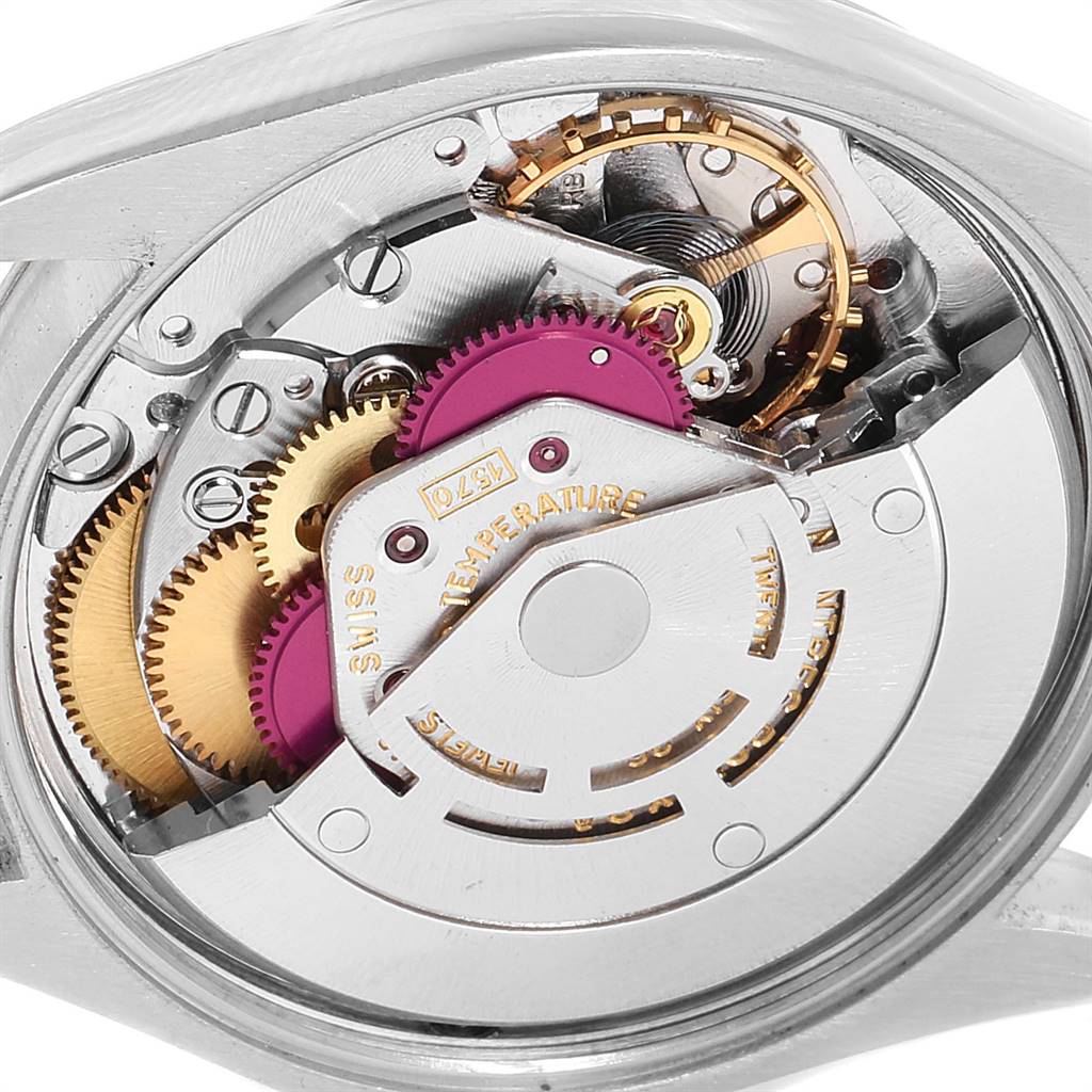 The image shows a close-up of the internal movement parts of the Rolex Vintage Collection 1002 Men
s Stainless Steel Silver Dial 1002 Men
s Stainless Steel Silver Dial model, including gears and mechanisms.