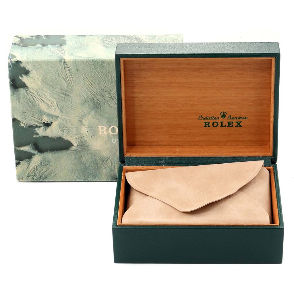 The image shows the open box of a Rolex Vintage Collection 16030 Men
s Stainless Steel Silver Dial 16030 Men
s Stainless Steel Silver Dial model, displaying the wooden interior and a suede pouch.