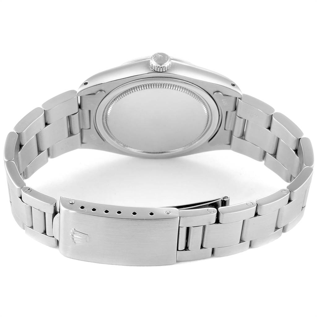 The image shows the back view of a Vintage Collection model watch by Rolex, highlighting the case back and the metal bracelet with the clasp open.