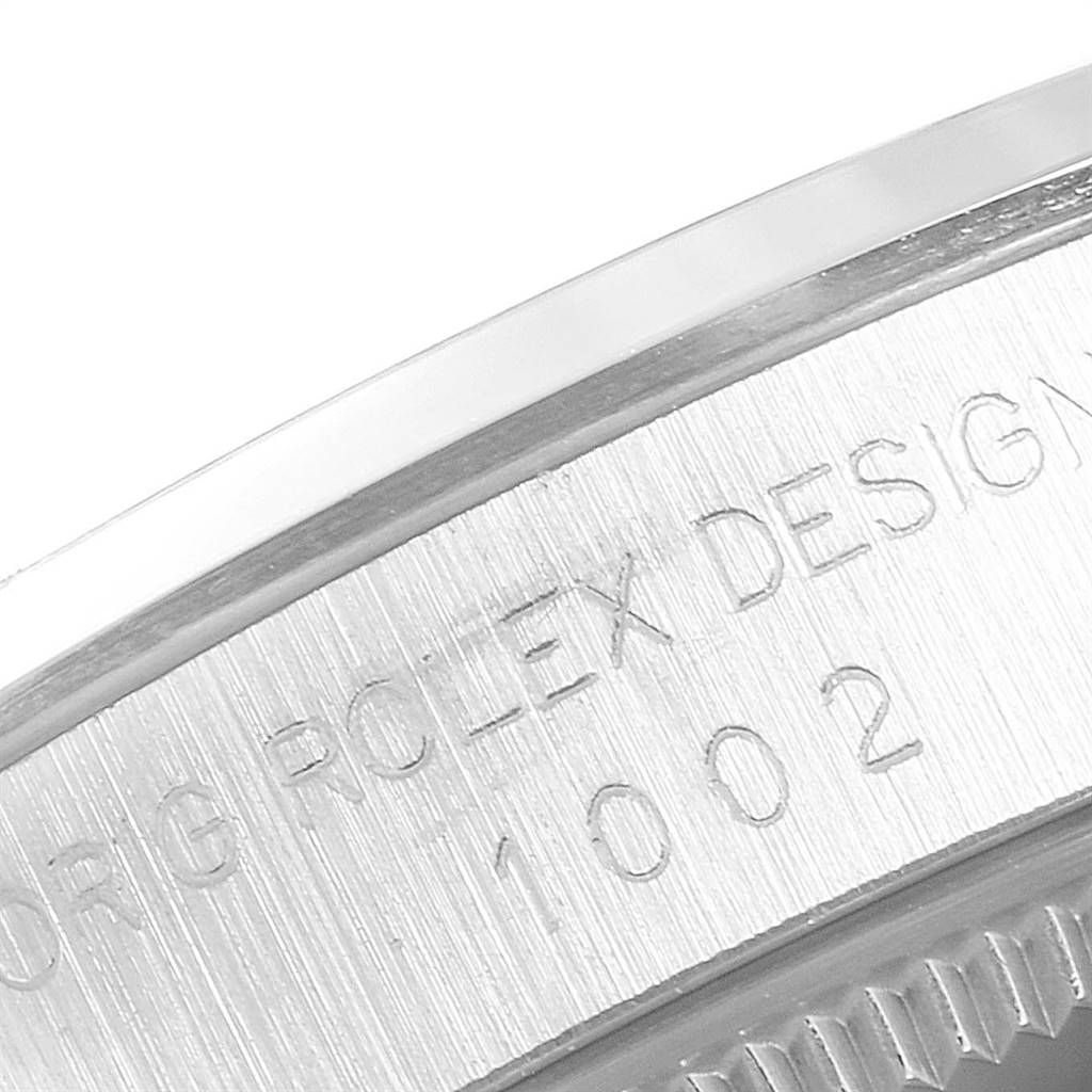 This image shows a close-up of the Rolex Vintage Collection 1002 Men
s Stainless Steel Silver Dial 1002 Men
s Stainless Steel Silver Dial model, focusing on the engraved design details on the watch
s side.