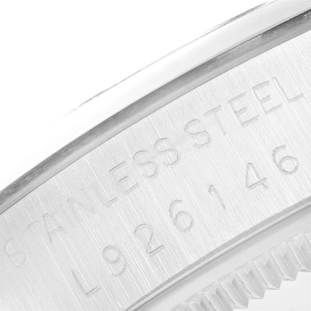 The image shows a close-up of the back case and edge of a Rolex Vintage Collection 1002 Men
s Stainless Steel Silver Dial 1002 Men
s Stainless Steel Silver Dial watch, highlighting the stainless steel marking and serial number.