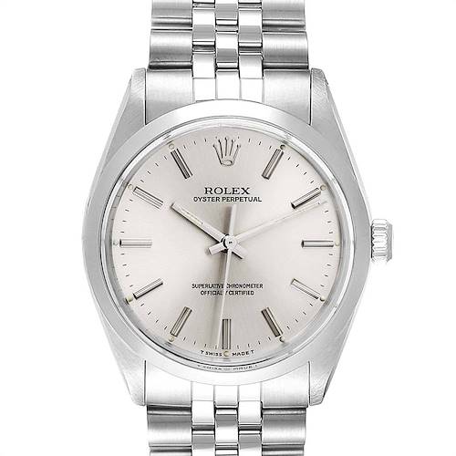 The Rolex Vintage Collection watch is shown from a top-down angle, highlighting its face, bezel, and part of the bracelet.