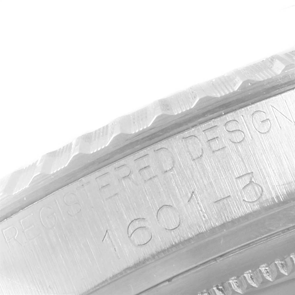 This is a close-up image of the side of a Rolex Vintage Collection 1601 Men
s Stainless Steel Silver Dial 1601 Men
s Stainless Steel Silver Dial watch, showing the engraved model number 1601-B.