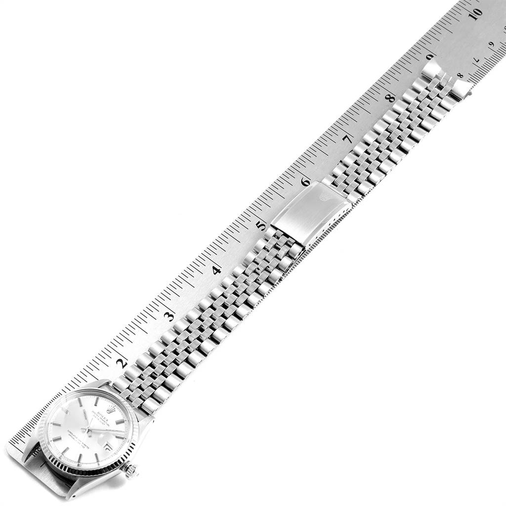 The image shows a Vintage Collection Rolex watch placed next to a ruler, highlighting its face and metal bracelet from an angled top view.
