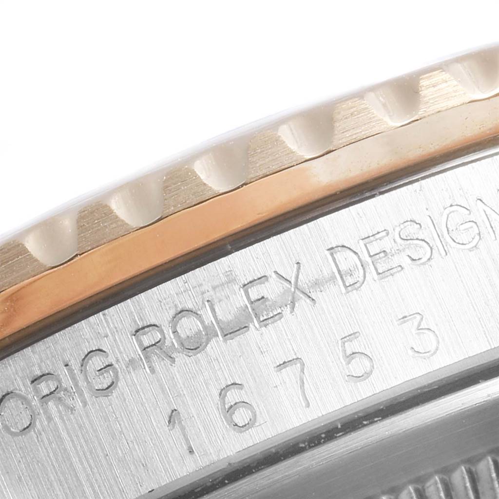 The image shows a close-up of the engraved bezel and case side of the Rolex Vintage Collection 16753 Men's Steel and Gold (two tone) Black Dial 16753 Men's Steel and Gold (two tone) Black Dial model.