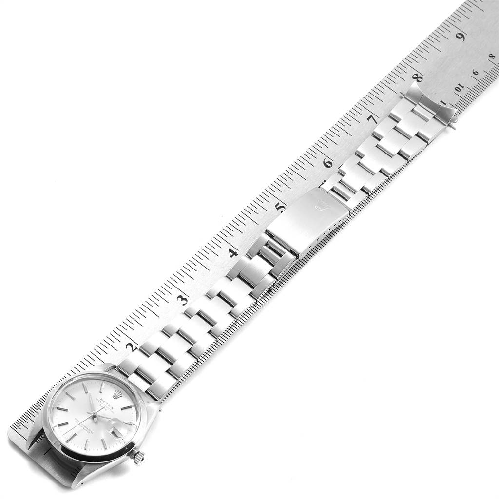 The Rolex Vintage Collection 15000 Men
s Stainless Steel Silver Dial 15000 Men
s Stainless Steel Silver Dial watch is shown flat, displaying the dial, bracelet, and clasp alongside a ruler for measurement.