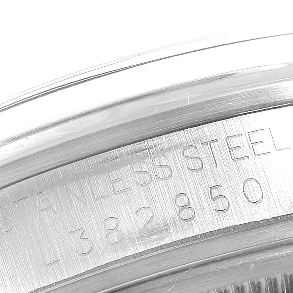 This close-up shows the stainless steel case of the Rolex Vintage Collection 15000 Men
s Stainless Steel Silver Dial 15000 Men
s Stainless Steel Silver Dial watch with an engraved serial number.
