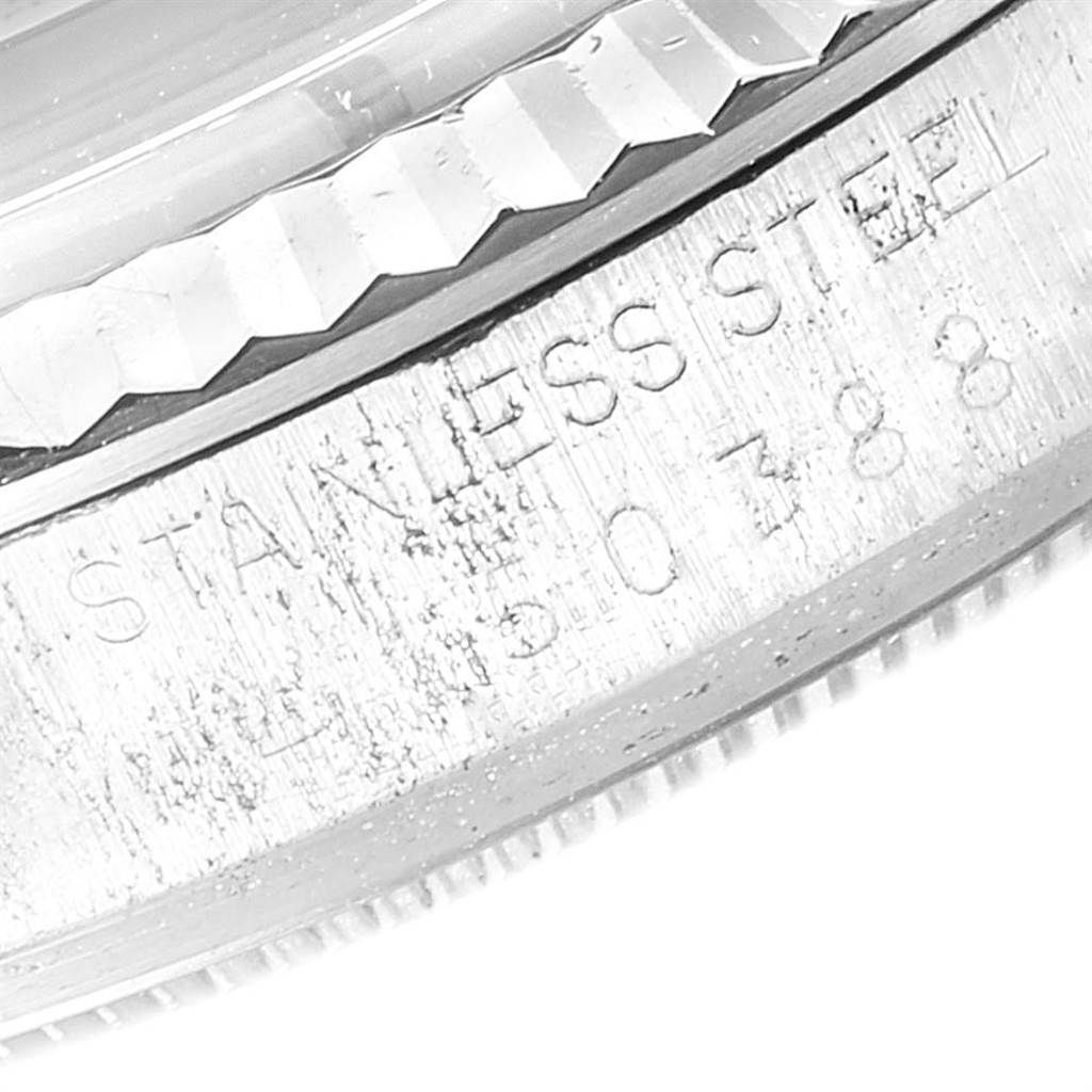 The image shows a close-up of the side of a Rolex Vintage Collection 1601 Men
s Stainless Steel Silver Dial 1601 Men
s Stainless Steel Silver Dial watch, highlighting the "Stainless Steel" engraving.