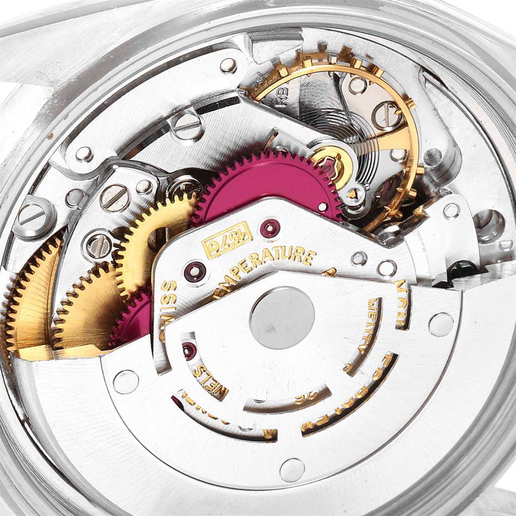 The image shows a close-up of the mechanical movement of a Rolex Vintage Collection 1601 Men
s Stainless Steel Silver Dial 1601 Men
s Stainless Steel Silver Dial model watch, highlighting gears and intricate components.