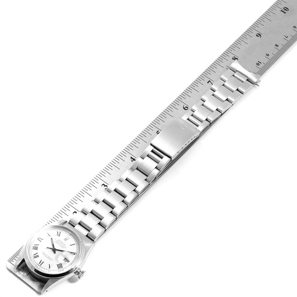 The image shows the Rolex Vintage Collection 1600 Men's Stainless Steel White Dial 1600 Men's Stainless Steel White Dial watch laid flat against a ruler, displaying its bracelet and clasp.