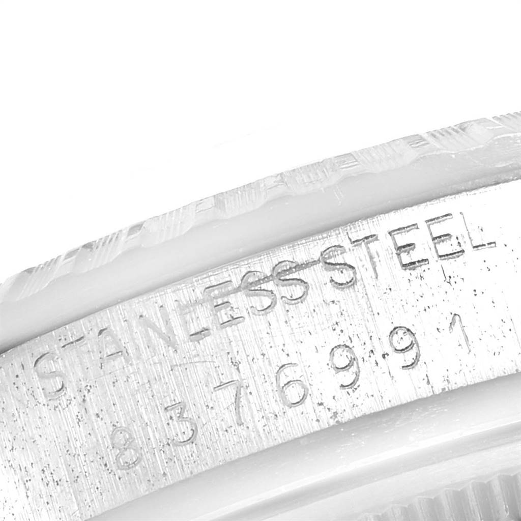 The image shows a close-up view of the serial number and "STAINLESS STEEL" engraving on the case of a Vintage Collection model by Rolex.