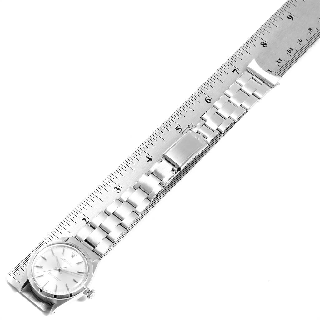 The image shows a flat, top-down view of the face and bracelet of a Vintage Collection model by Rolex alongside a ruler.