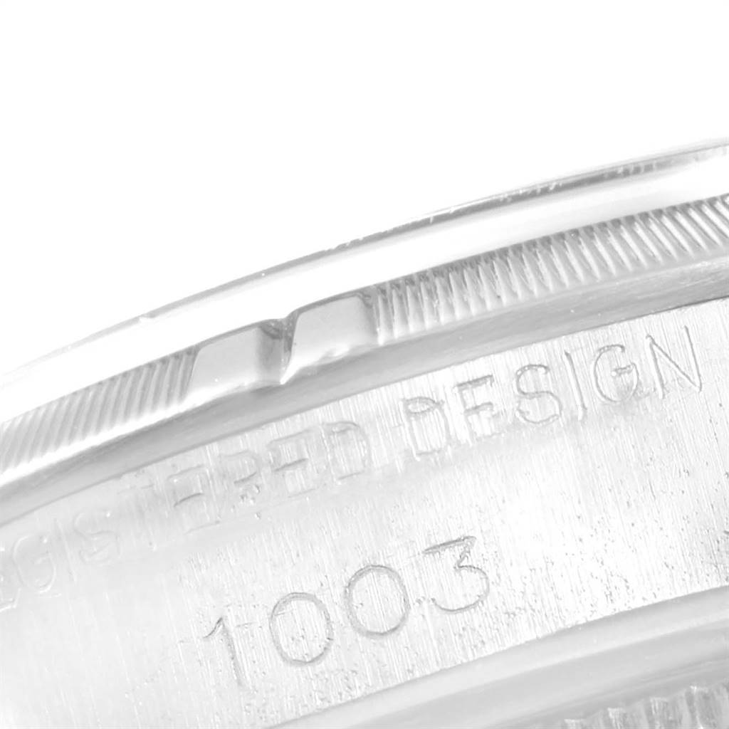 The image shows a close-up of the bezel and case side of the Rolex Vintage Collection 1003 Men
s Stainless Steel Silver Dial 1003 Men
s Stainless Steel Silver Dial model, revealing engravings.