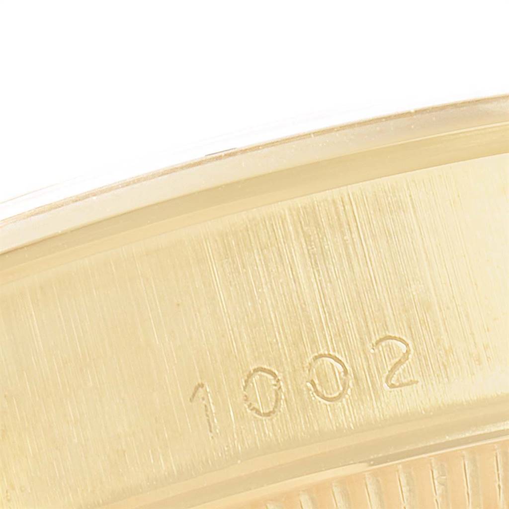 This close-up image shows the engraved model number "1002" on the casing of the Rolex Vintage Collection 1002 Men
s Yellow Gold Champagne Dial 1002 Men
s Yellow Gold Champagne Dial watch.