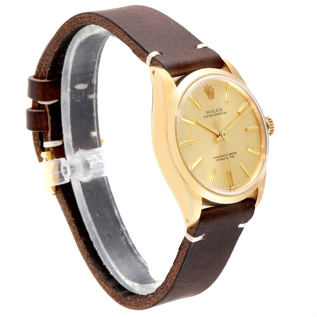 The Vintage Collection Rolex watch is shown at a slight angle, displaying the face, bezel, crown, and brown leather strap.
