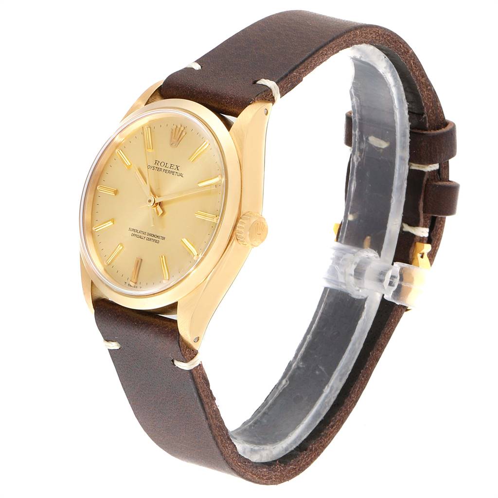 The image shows a Rolex Vintage Collection 1002 Men
s Yellow Gold Champagne Dial 1002 Men
s Yellow Gold Champagne Dial watch at a slight angle, highlighting its brown leather strap, gold case, and dial.