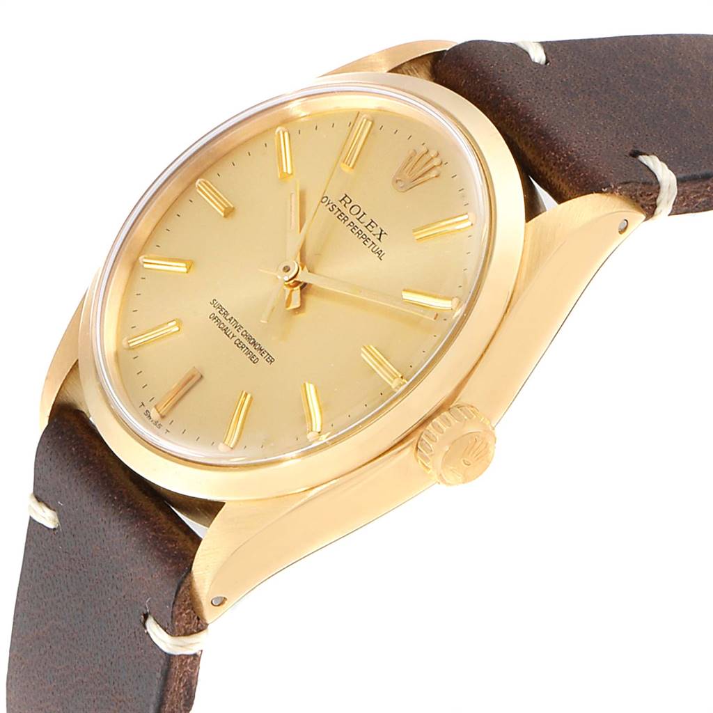 The image shows a close-up of the Rolex Vintage Collection 1002 Men
s Yellow Gold Champagne Dial 1002 Men
s Yellow Gold Champagne Dial watch at an angled view, highlighting the dial, crown, and leather strap.