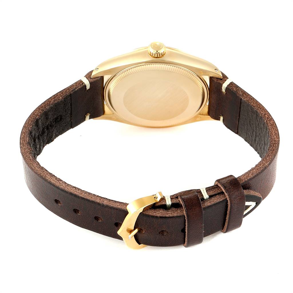 The image shows the back case and leather strap of a Rolex Vintage Collection 1002 Men
s Yellow Gold Champagne Dial 1002 Men
s Yellow Gold Champagne Dial watch from a rear angle.