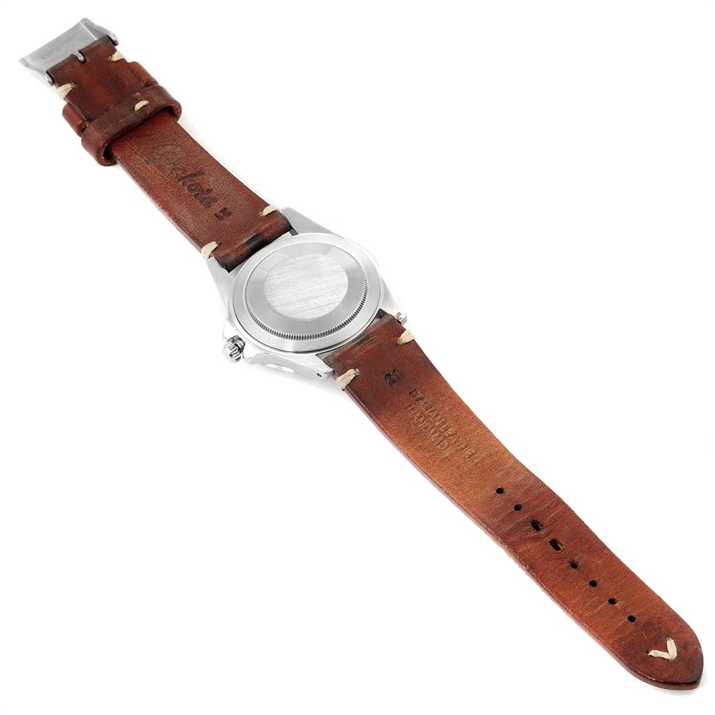 The image shows the back case and leather strap of a Rolex Vintage Collection 1675 Men
s Stainless Steel Black Dial 1675 Men
s Stainless Steel Black Dial watch.