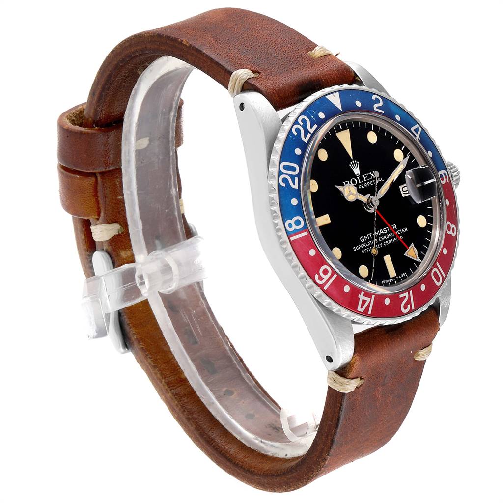 The image shows a Vintage Collection Rolex GMT-Master watch at a three-quarter angle, highlighting its brown leather strap and red-blue bezel.