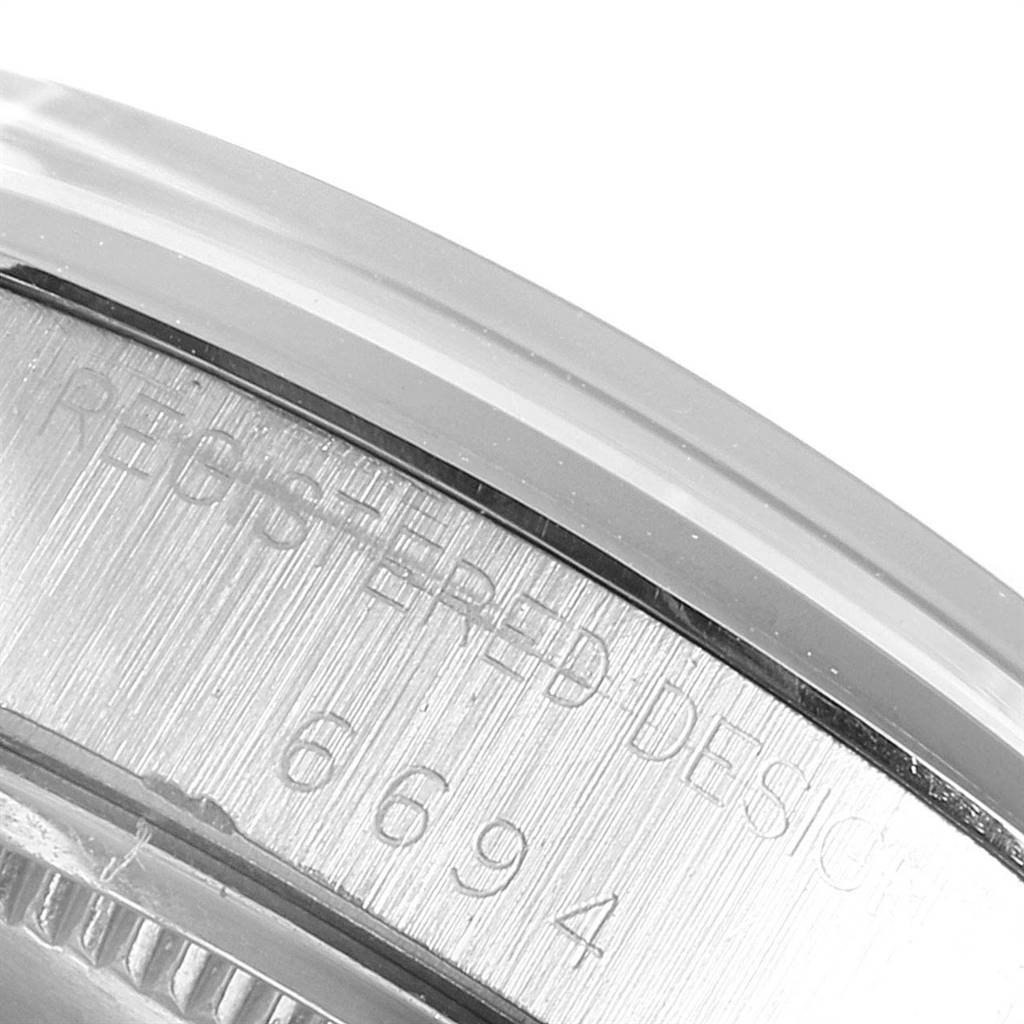 This image shows the engraved serial number on the side of the bezel of a Rolex Vintage Collection 6694 Men's Stainless Steel Silver Dial 6694 Men's Stainless Steel Silver Dial model.