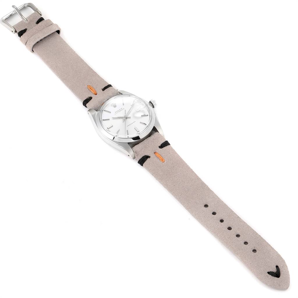 The Rolex Vintage Collection 6694 Men's Stainless Steel Silver Dial 6694 Men's Stainless Steel Silver Dial watch is shown in a top-down angle, featuring its dial, case, and full beige strap.