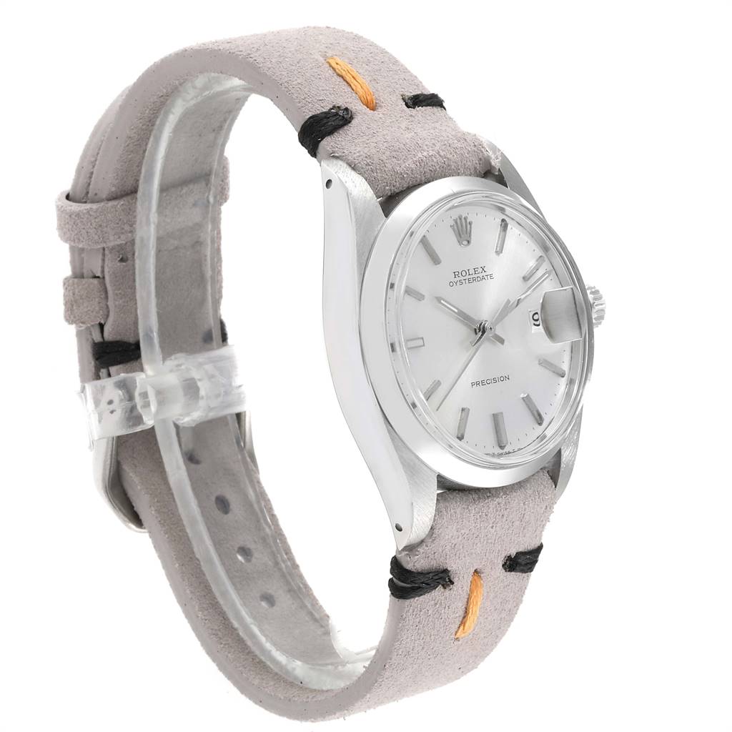 The image shows a side angle of the Rolex Vintage Collection 6694 Men's Stainless Steel Silver Dial 6694 Men's Stainless Steel Silver Dial watch, highlighting the dial, bezel, and suede strap.