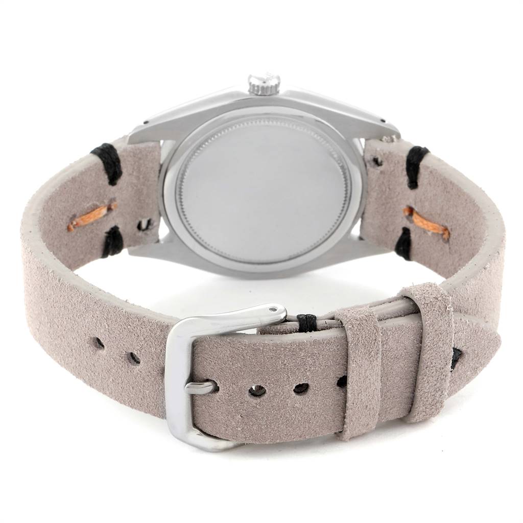 The image shows the back view of a Rolex Vintage Collection 6694 Men's Stainless Steel Silver Dial 6694 Men's Stainless Steel Silver Dial watch, highlighting the case back and beige leather strap with buckle.