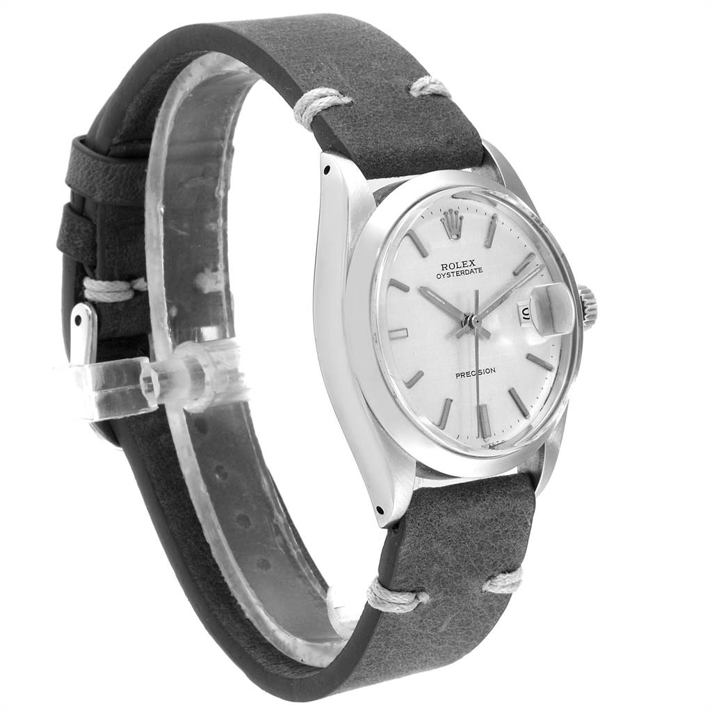 The image shows a side angle of a Rolex Vintage Collection 6694 Men
s Stainless Steel Silver Dial 6694 Men
s Stainless Steel Silver Dial watch, highlighting its dial, case, and leather strap.