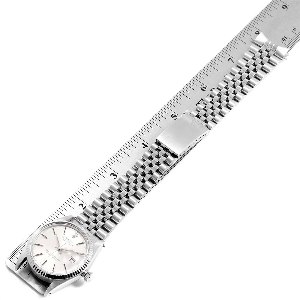 The Rolex Vintage Collection 16014 Men
s Stainless Steel Silver Dial 16014 Men
s Stainless Steel Silver Dial watch is shown from a top-down angle with the dial, bracelet, and clasp visible, alongside a measuring ruler.