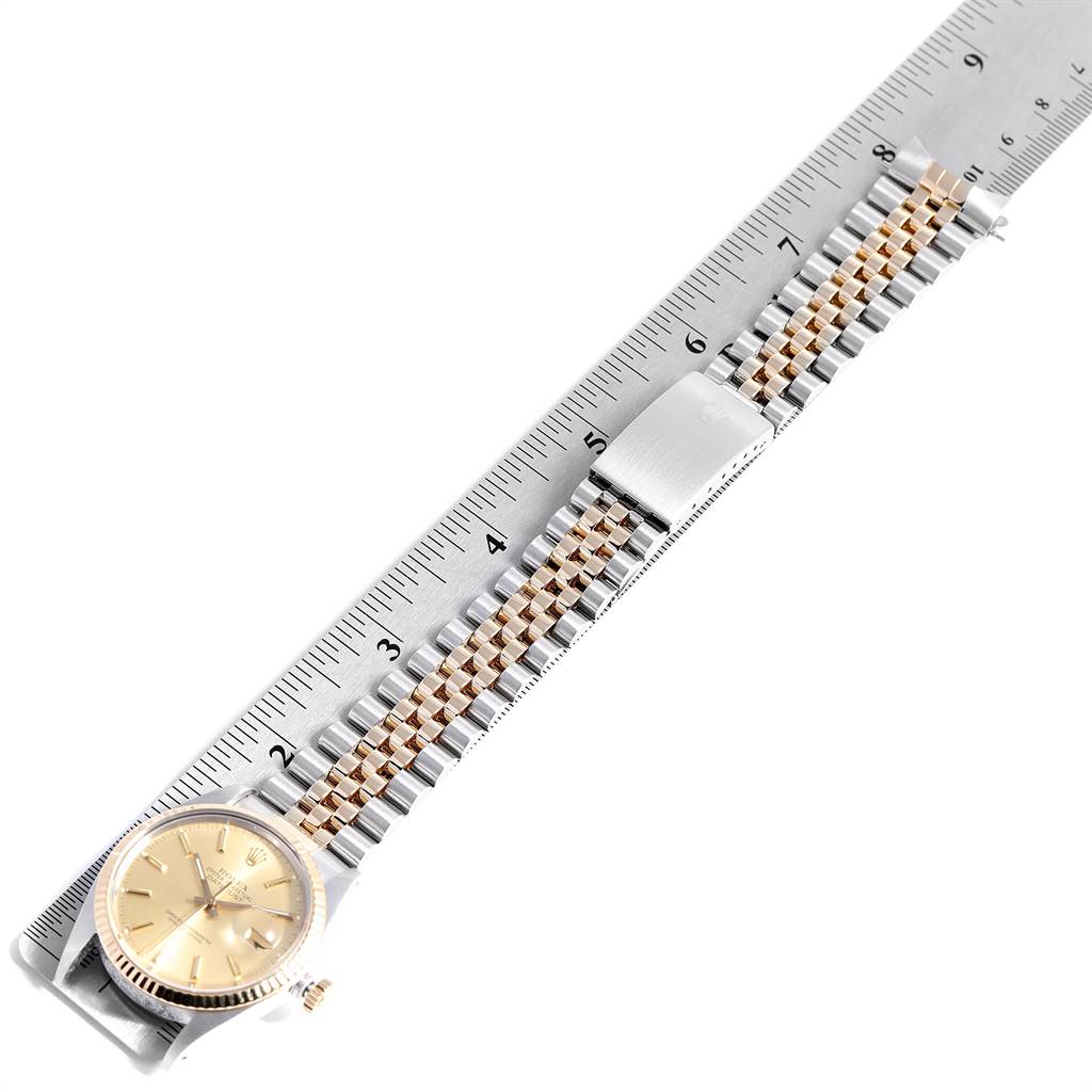 This image shows a Rolex Vintage Collection 16013 Men's Stainless Steel Champagne Dial 16013 Men's Stainless Steel Champagne Dial watch from above, featuring the face, bezel, and bracelet laid out alongside a ruler.