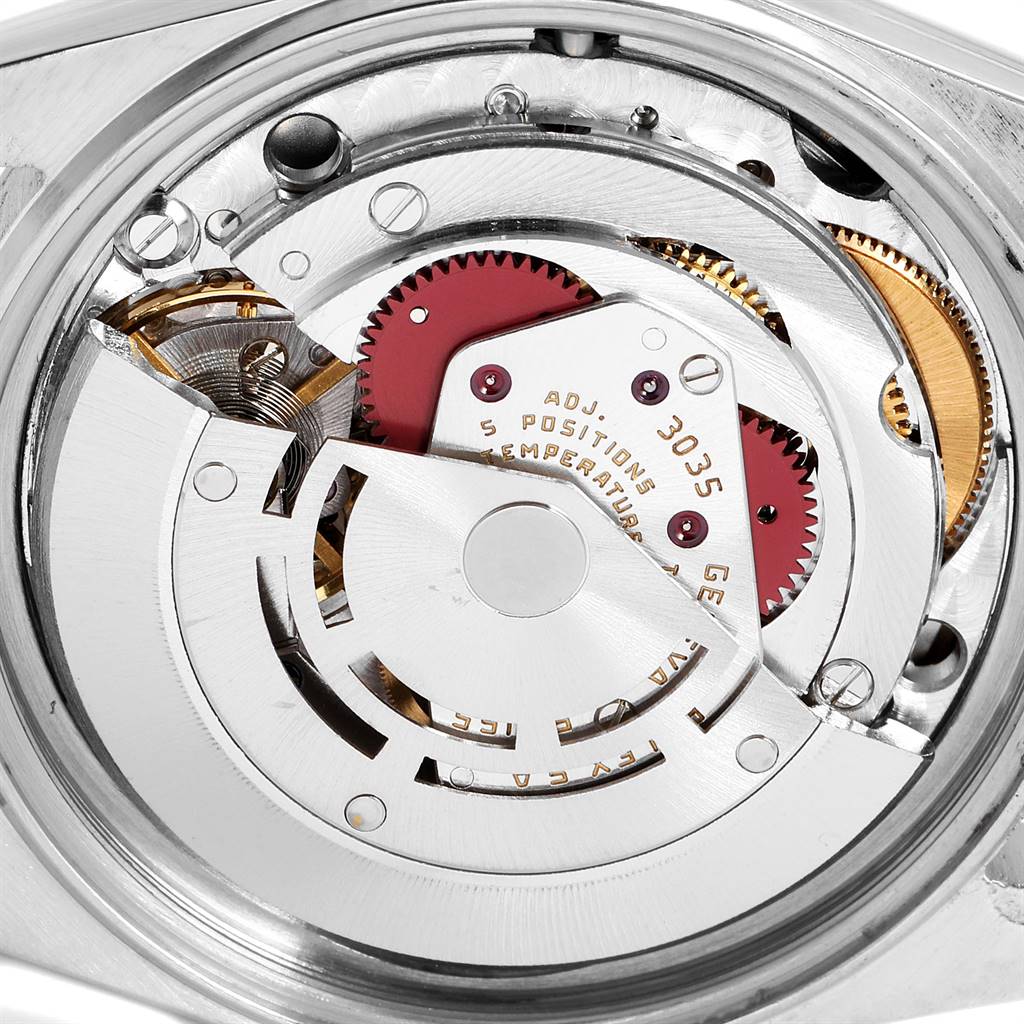 The image shows the internal mechanism of a Vintage Collection Rolex watch, highlighting the gears and rotor.