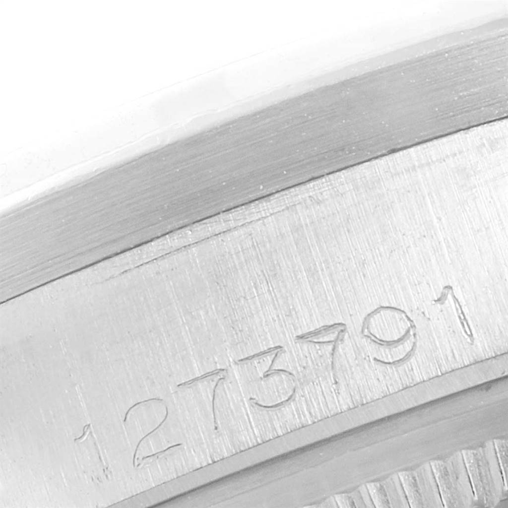 This image shows the engraved serial number on the case of a Vintage Collection Rolex watch.