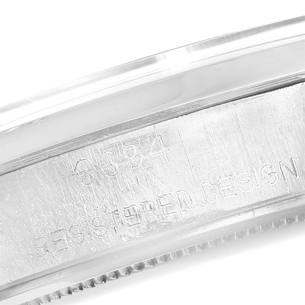 The image shows a close-up of the side of the case of a Rolex Vintage Collection 6694 Men
s Stainless Steel Silver Dial 6694 Men
s Stainless Steel Silver Dial watch, displaying part of the serial number and "REGISTERED DESIGN".
