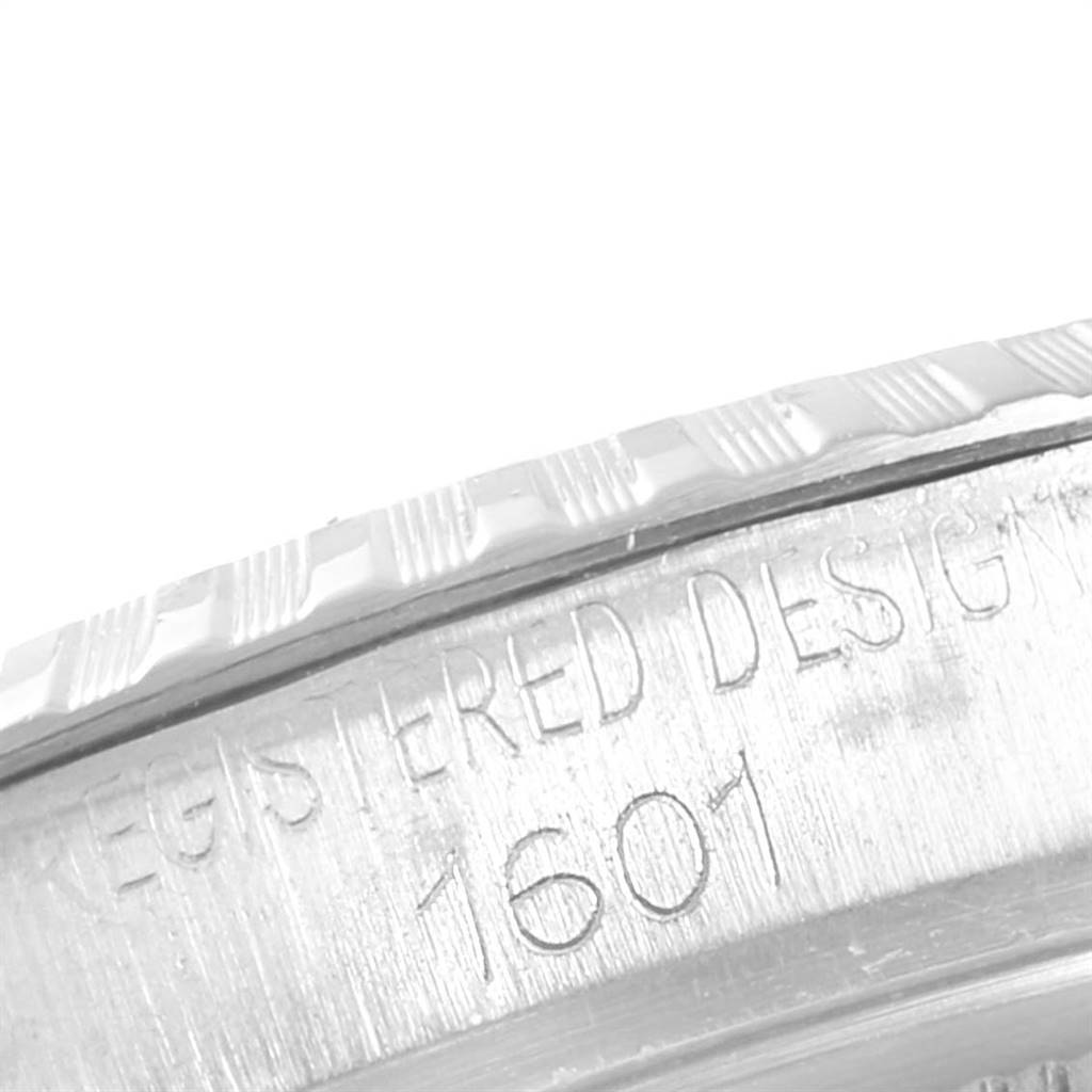 The image shows a close-up of the side bezel and case of the Rolex Vintage Collection 1601 Men
s Stainless Steel Silver Dial 1601 Men
s Stainless Steel Silver Dial model, featuring the engraved design number 1601.