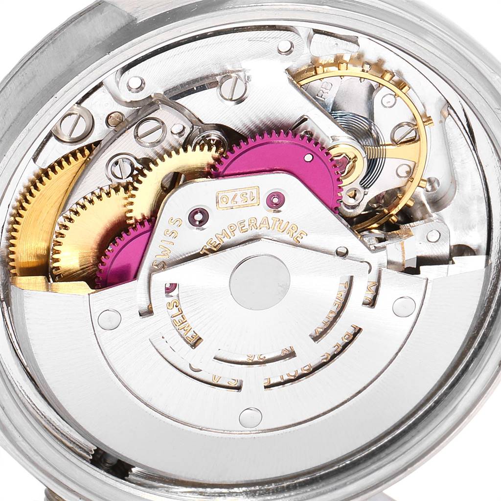 The image shows the inner mechanics of a Rolex Vintage Collection 1601 Men
s Stainless Steel Silver Dial 1601 Men
s Stainless Steel Silver Dial watch at an angled close-up view.