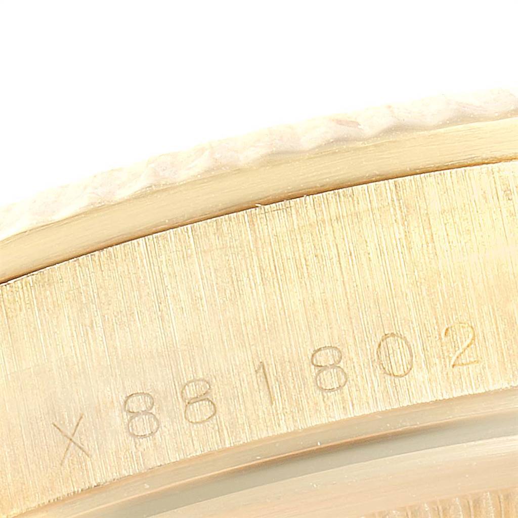 This close-up image shows part of the engraved serial number on the case of the Rolex Vintage Collection 15238 Men's Yellow Gold Champagne Dial 15238 Men's Yellow Gold Champagne Dial watch.