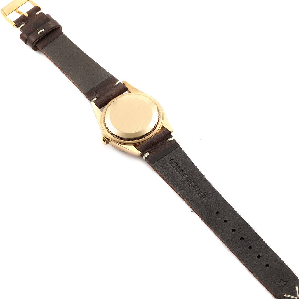 The image shows the back and brown leather strap of a Vintage Collection model by Rolex.