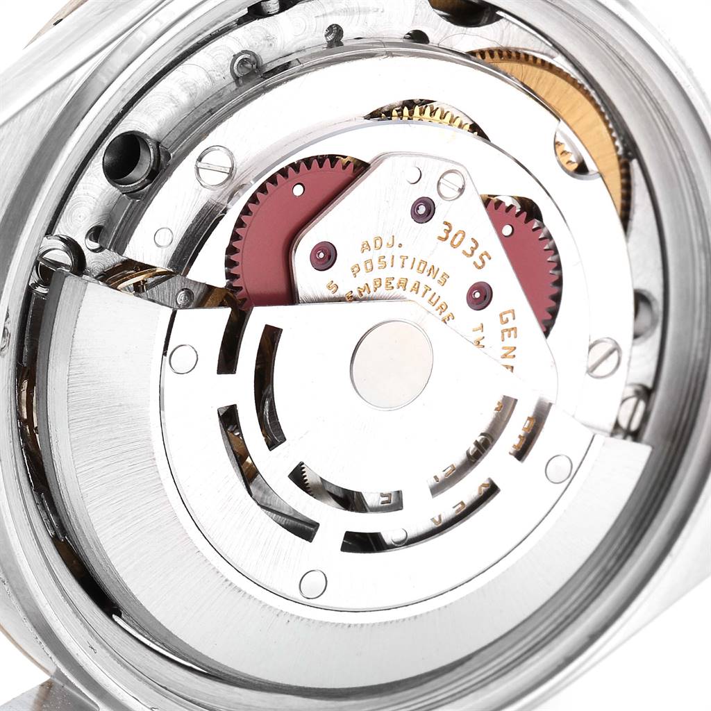 The image shows the internal mechanical parts of a Vintage Collection Rolex watch, viewed from the case-back angle.