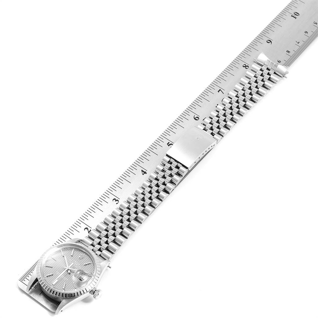 The Rolex Vintage Collection 16030 Men's Stainless Steel Grey Dial 16030 Men's Stainless Steel Grey Dial watch is displayed at an angle, showing the face, bracelet, and clasp, positioned next to a ruler.