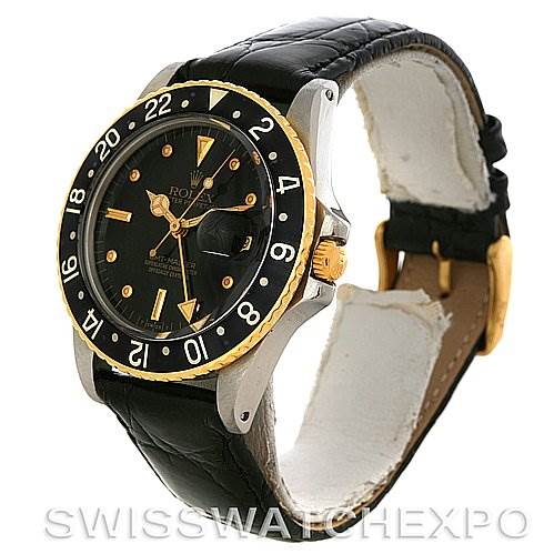 The image shows a side-angle view of a Rolex Vintage Collection 1675 Men's Stainless Steel Black Dial 1675 Men's Stainless Steel Black Dial watch, featuring a black bezel and strap, and a gold crown and accents.