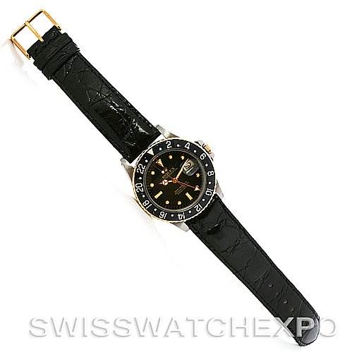 This image shows a top-down view of a Rolex Vintage Collection 1675 Men's Stainless Steel Black Dial 1675 Men's Stainless Steel Black Dial watch with a black leather strap and a black bezel with a numbered dial.